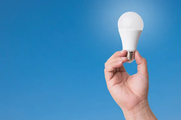 Mano que muestra una bombilla led